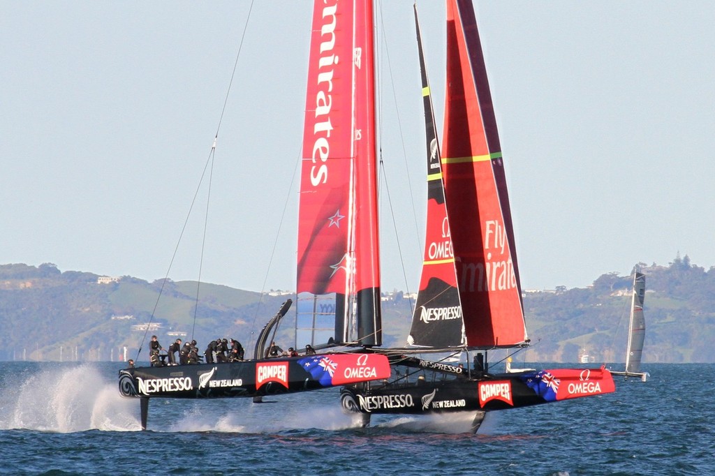 IMG 8417 - Emirates Team NZ at warp speed. Gennaker now drawing fully as it was in the image taken before the gybe (IMG 8302). ETNZ is still running near dead downwind, evidenced by the angle of the catamaran in the background, which is reaching across the breeze. © Richard Gladwell www.photosport.co.nz